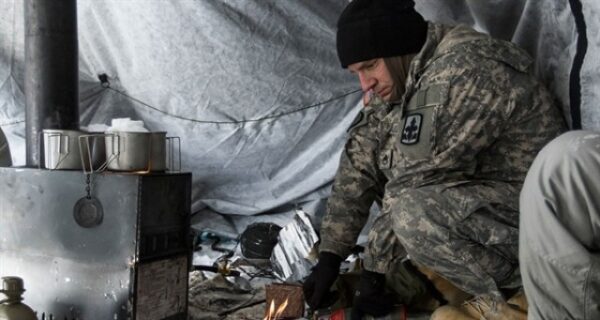 Soldier using the Hunter Tent Stove
