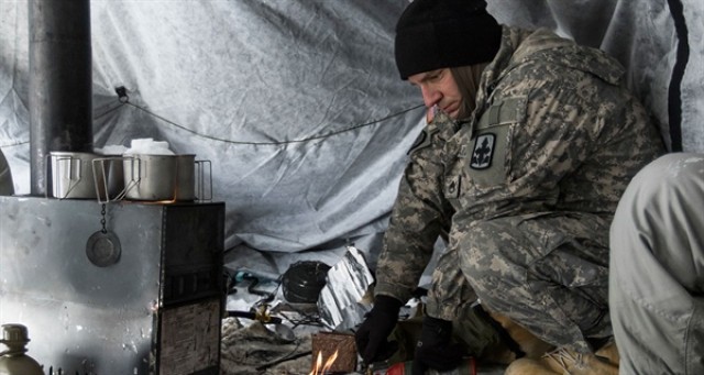 Soldier using the Hunter Tent Stove